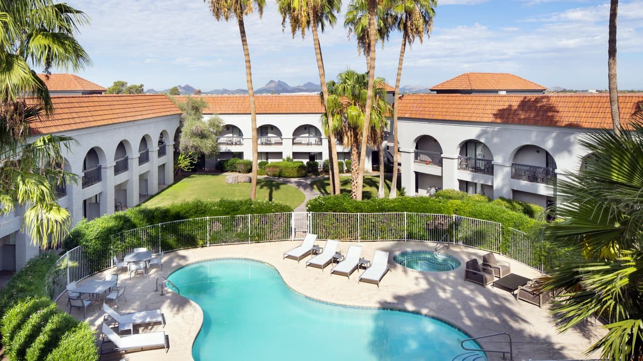 Four Points by Sheraton courtyard pool with palms and Tucson mountains.